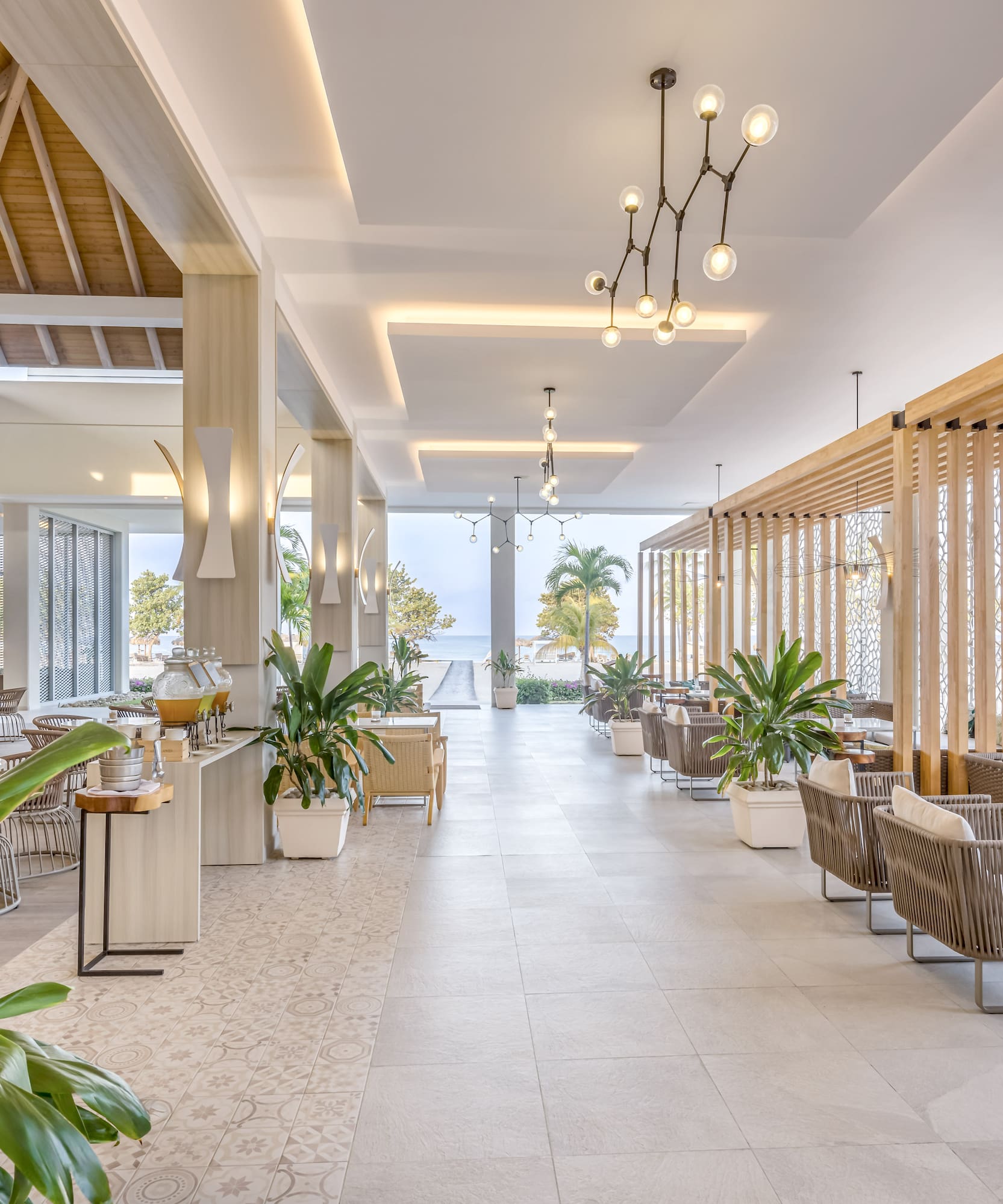 a room with tables and chairs and plants