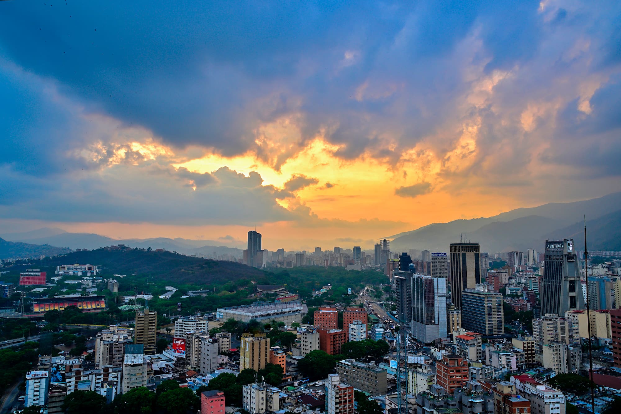 a city with many buildings and mountains in the background