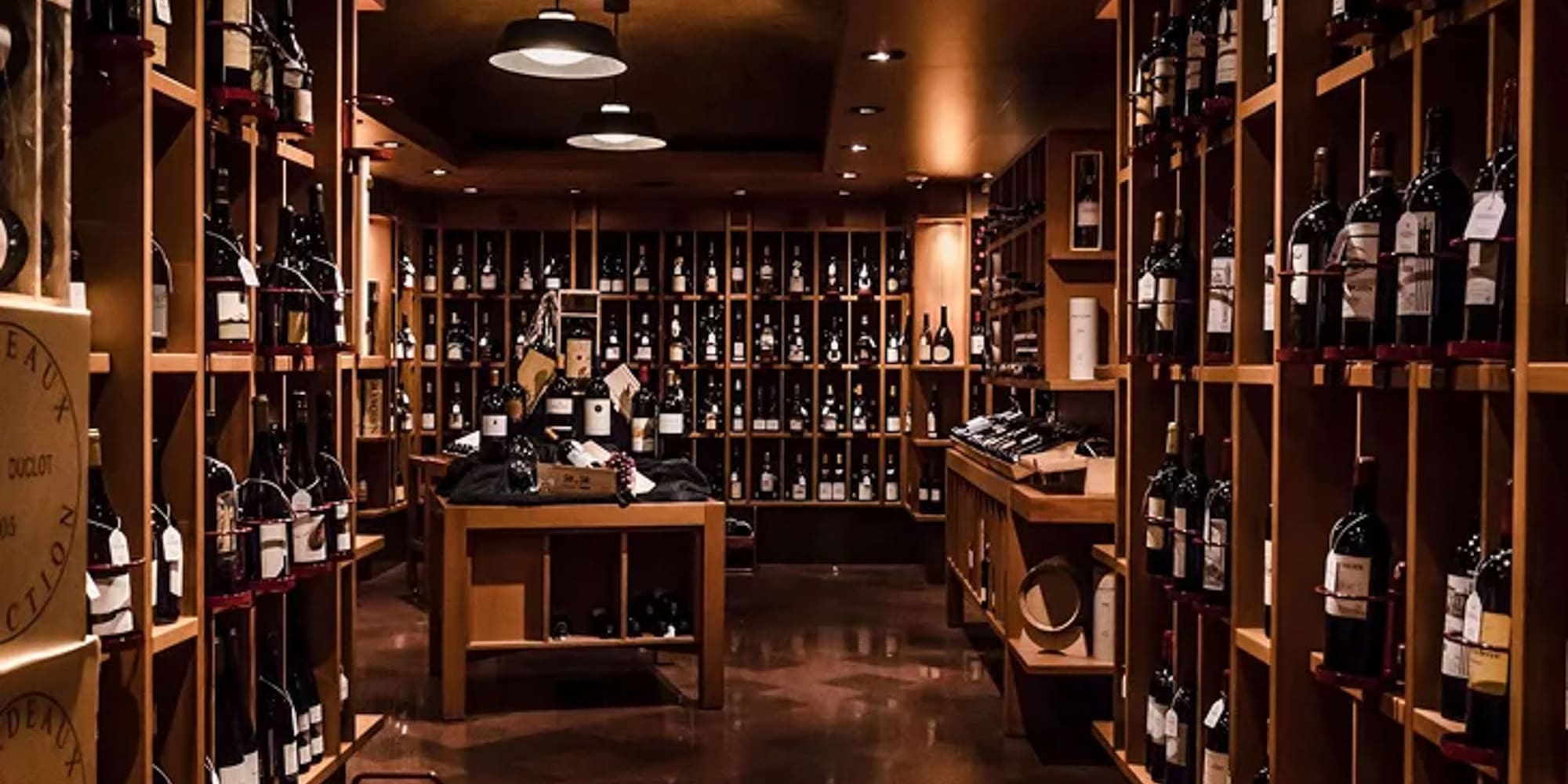 a room with shelves of wine bottles