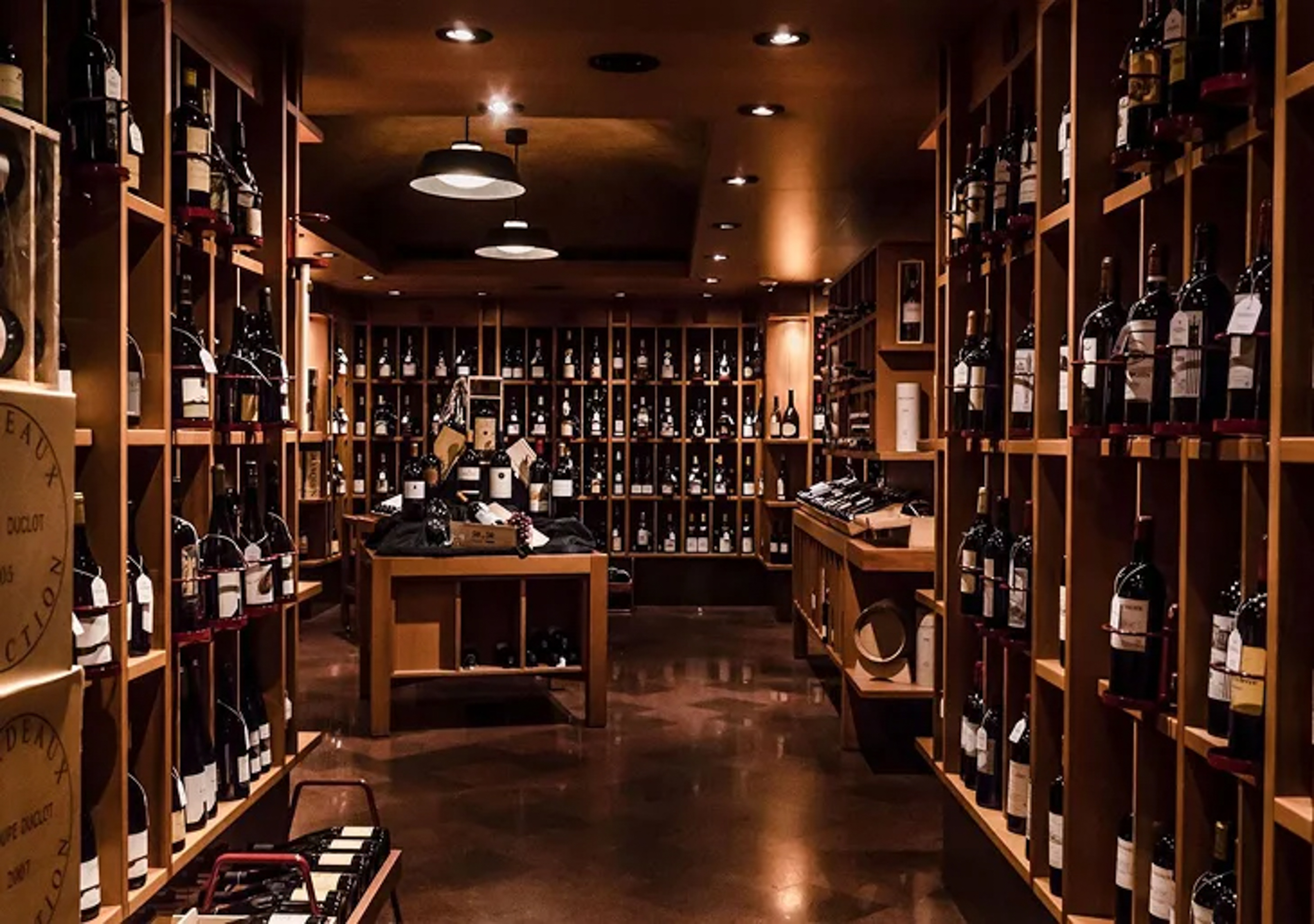 a room with shelves of wine bottles