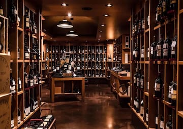 a room with shelves of wine bottles