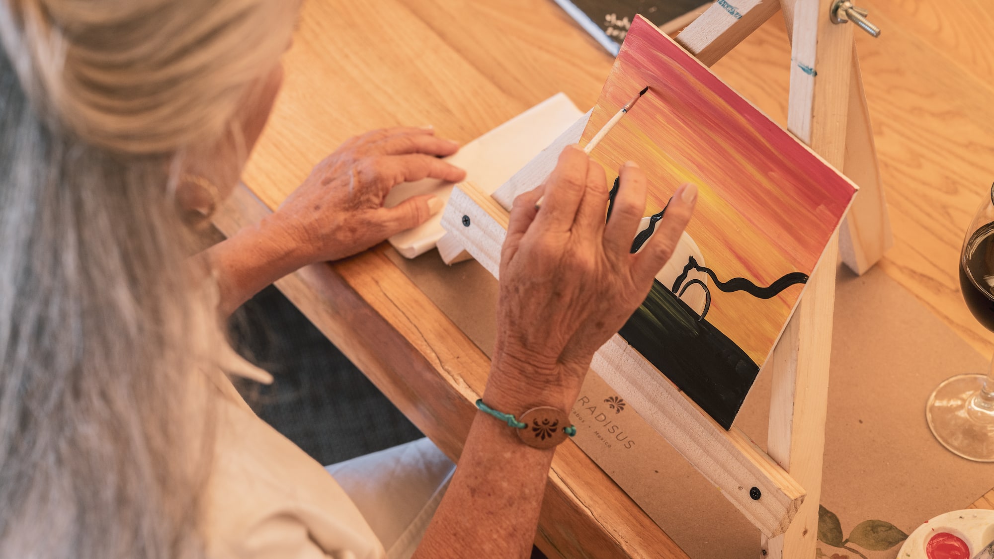 a person painting on a easel
