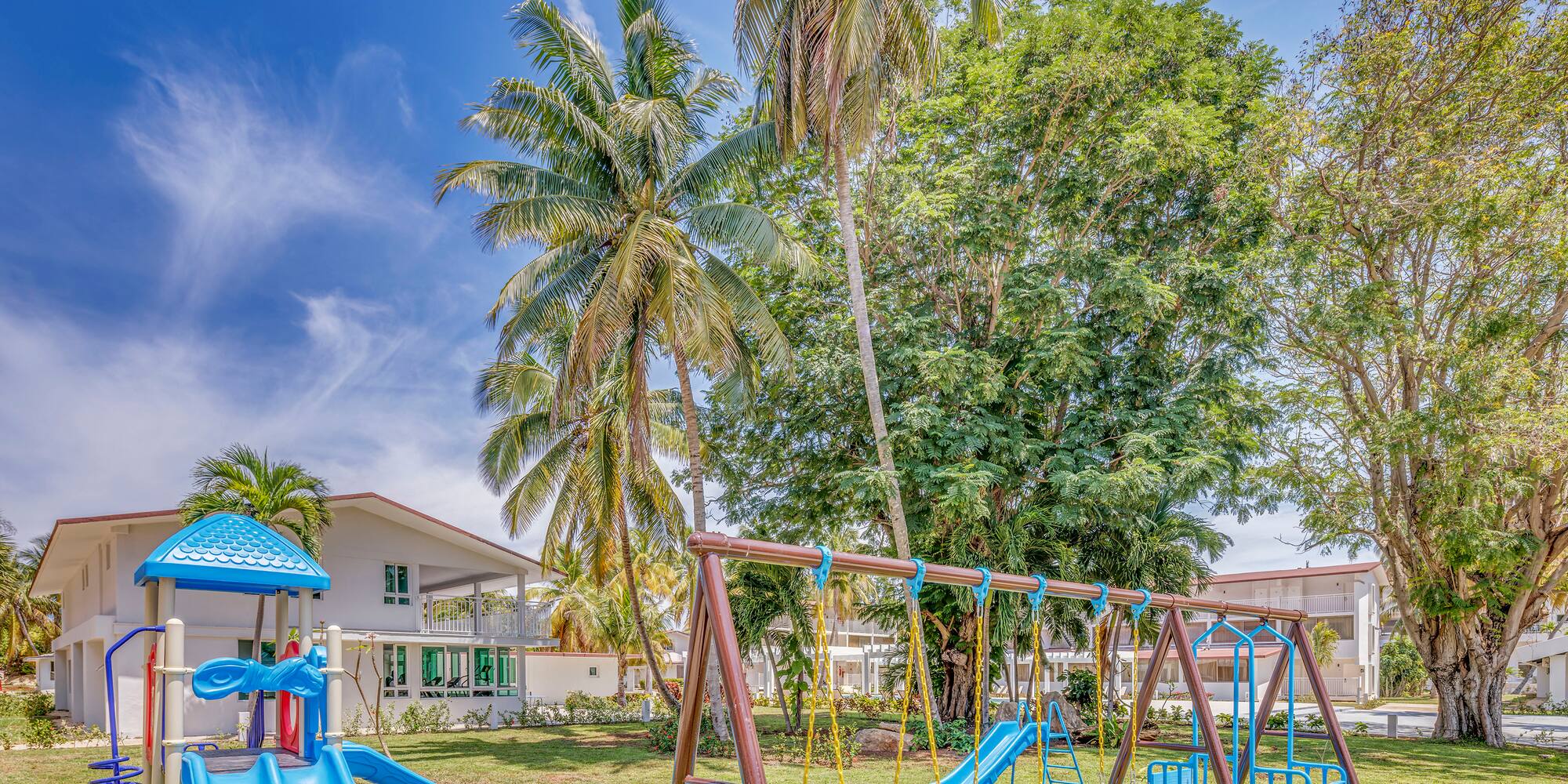 a playground with a slide and a slide in a yard