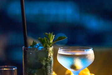 a glass of liquid and a drink on a table