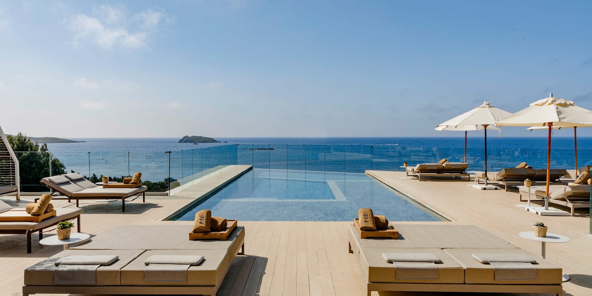 a pool with lounge chairs and umbrellas on a deck