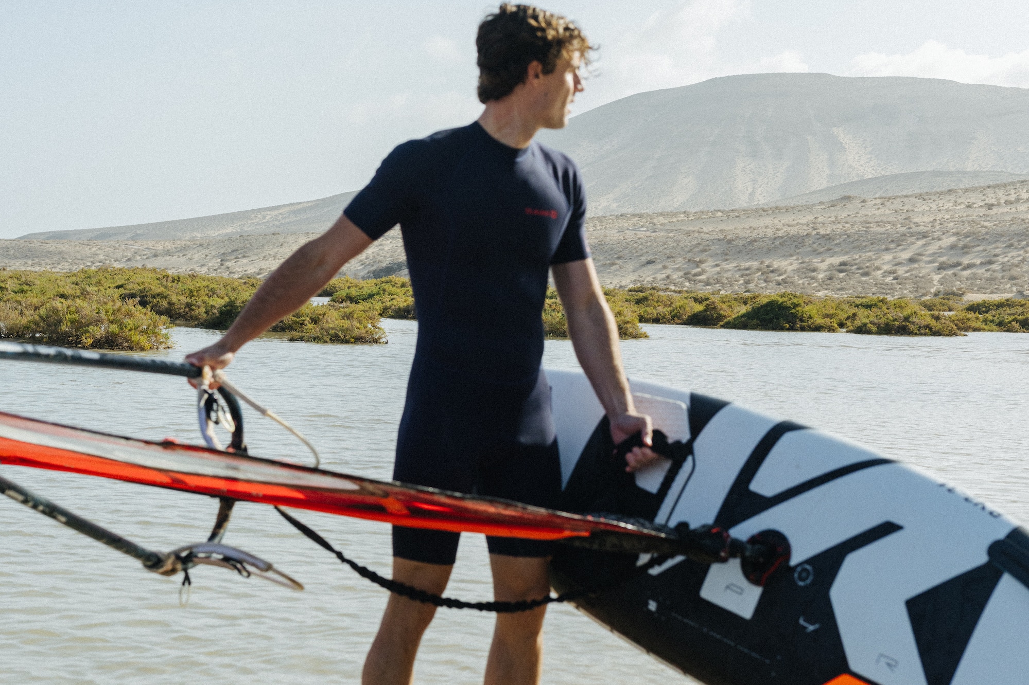a man holding a surfboard in the water