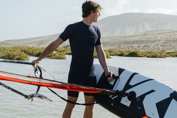 a man holding a surfboard in the water