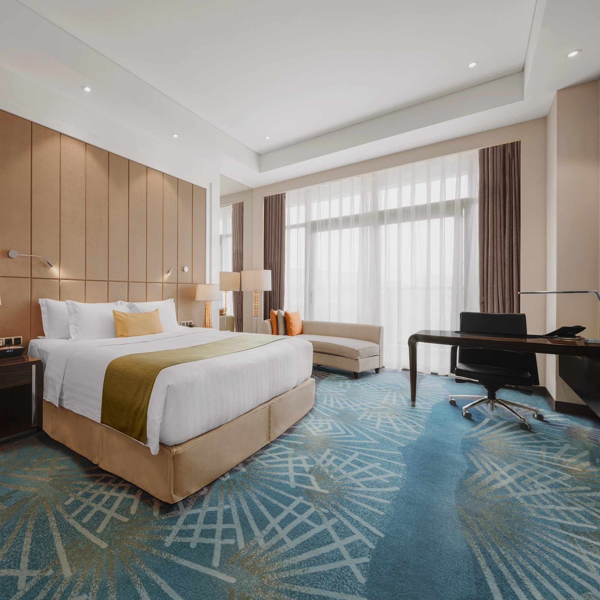 a room with a bed and desk