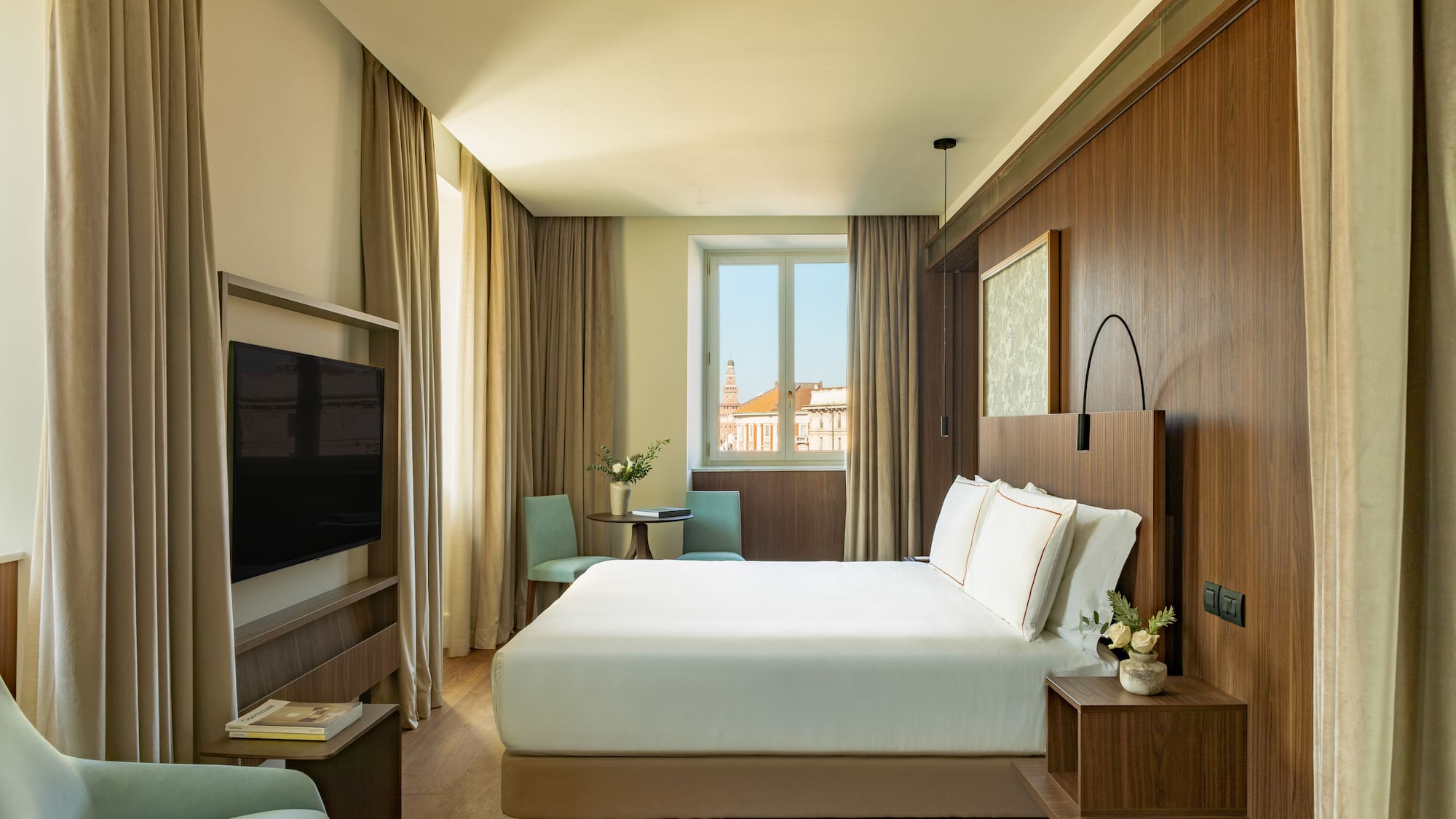 a room with a bed and a television