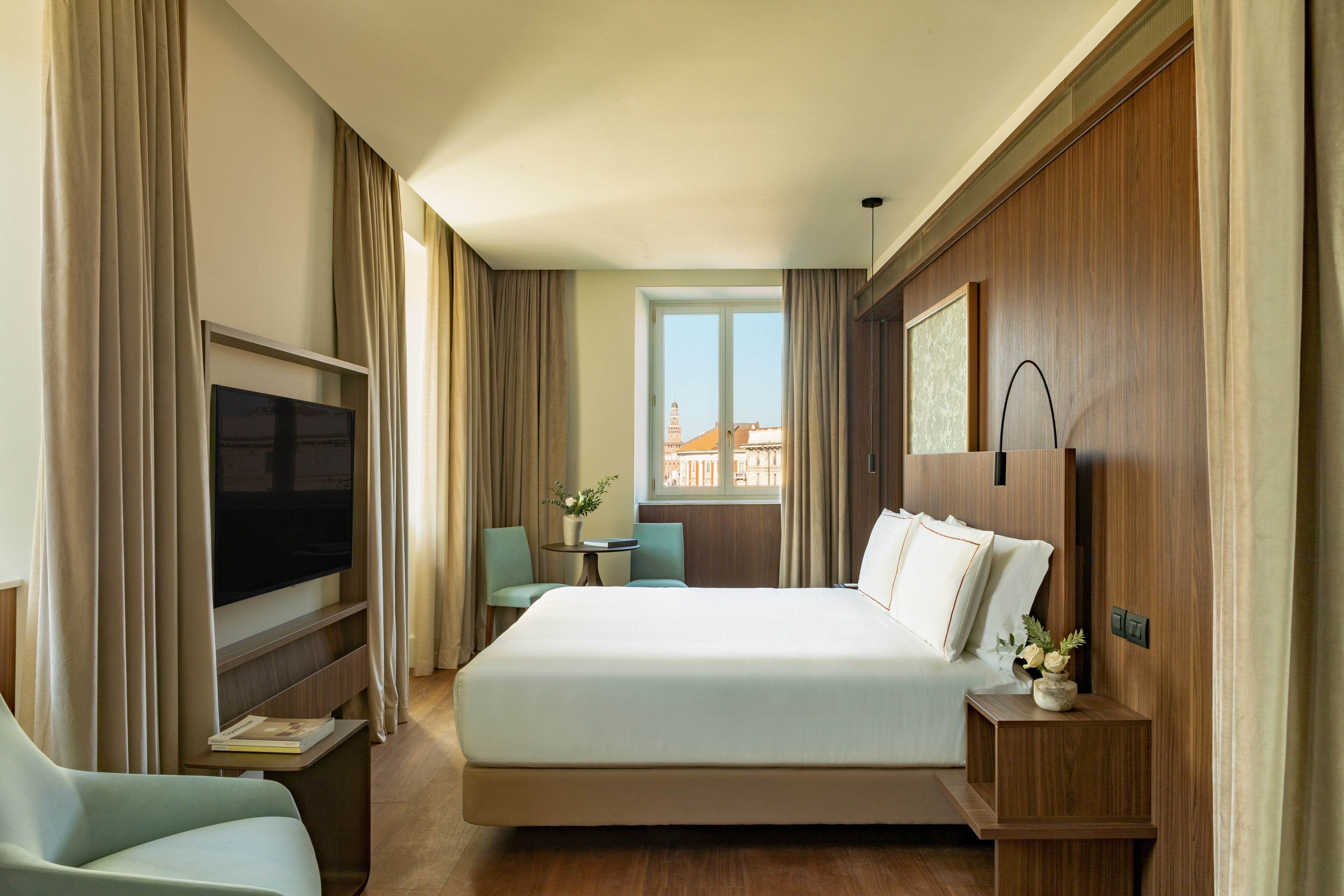 a room with a bed and a television