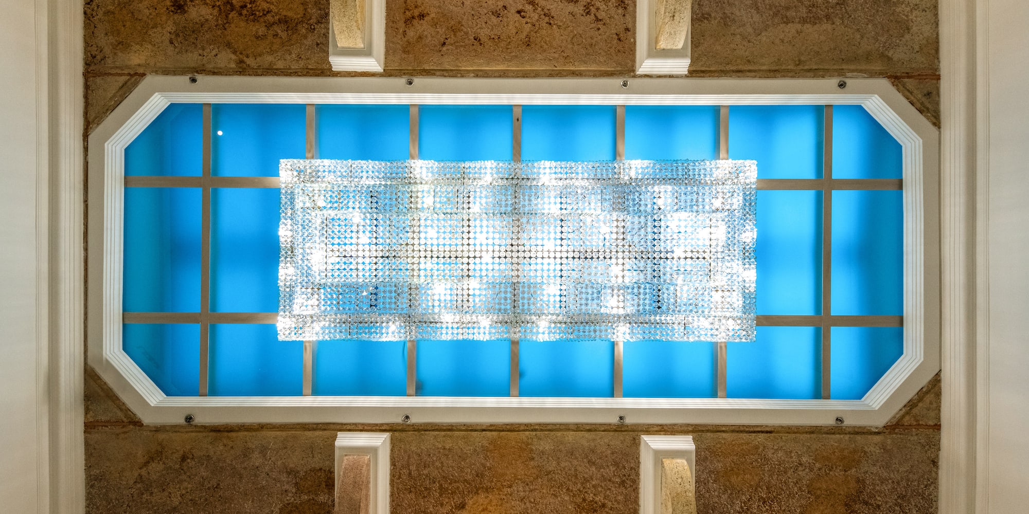 a light fixture on a blue ceiling