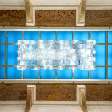 a light fixture on a blue ceiling