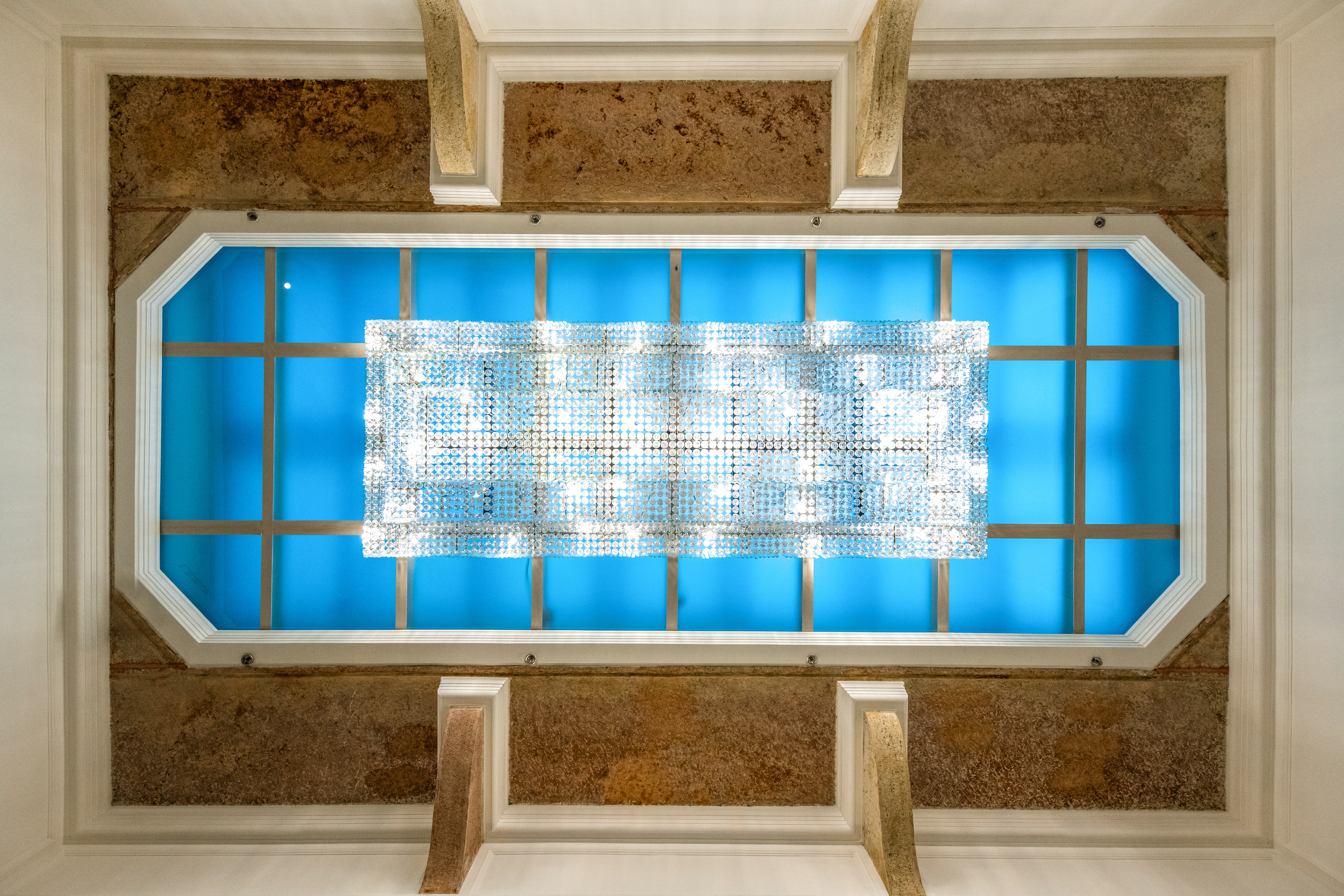 a light fixture on a blue ceiling