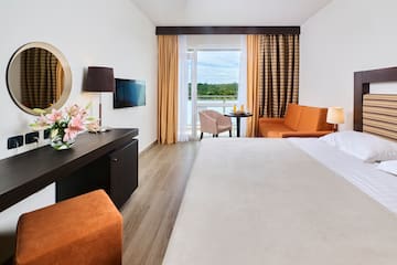 a room with a bed and a table and chairs