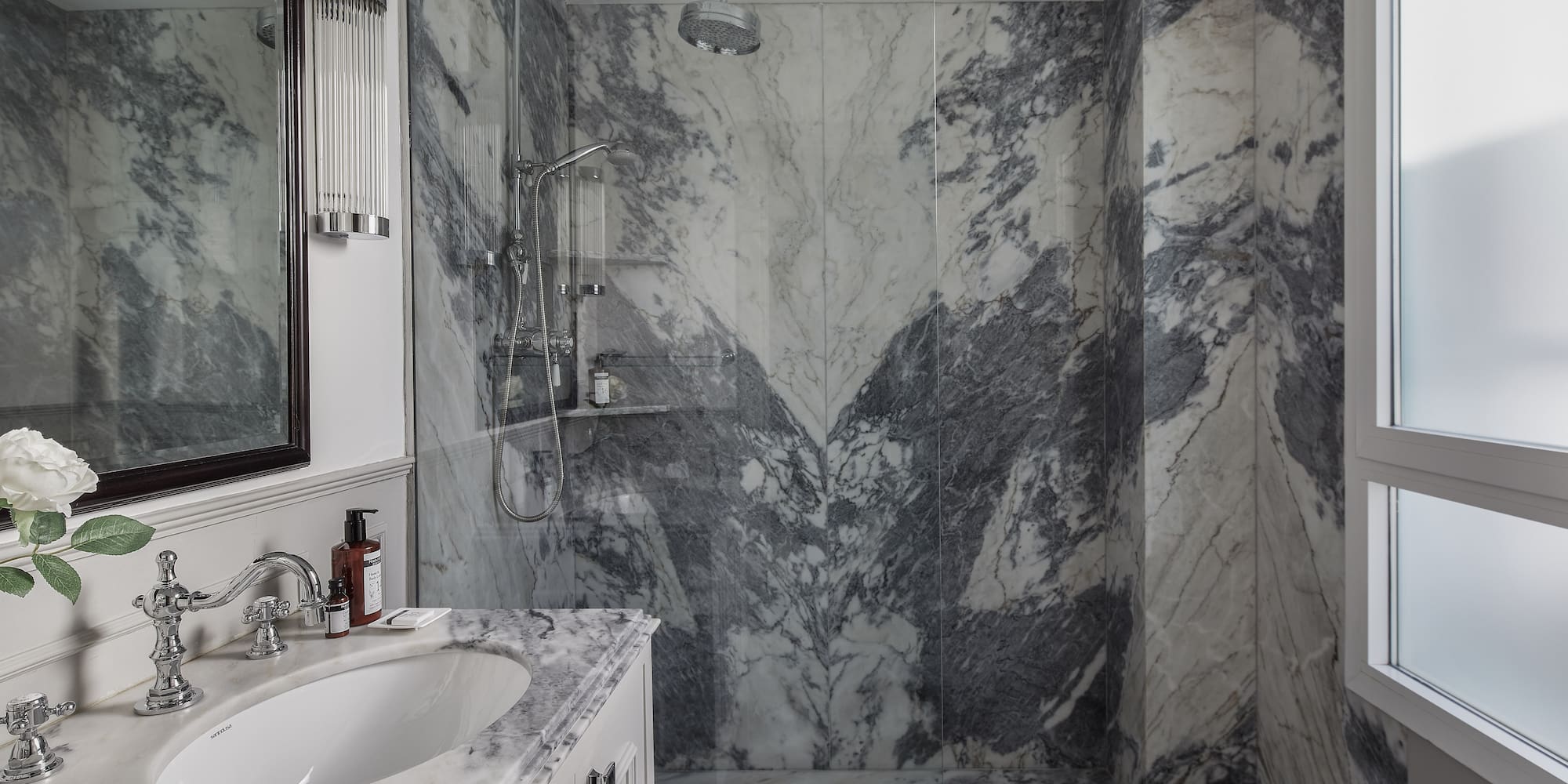 a bathroom with marble walls and a sink