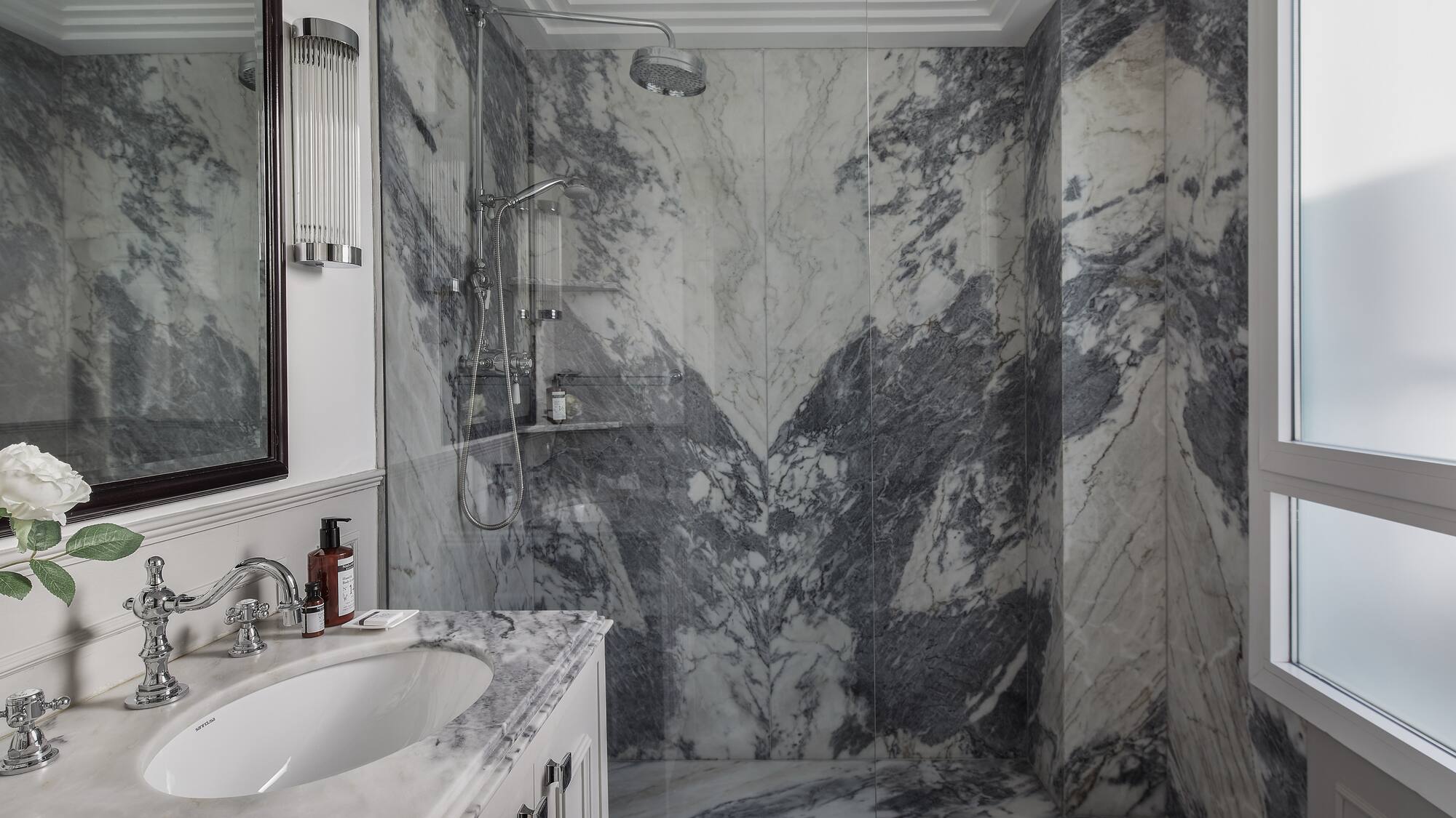 a bathroom with marble walls and a sink