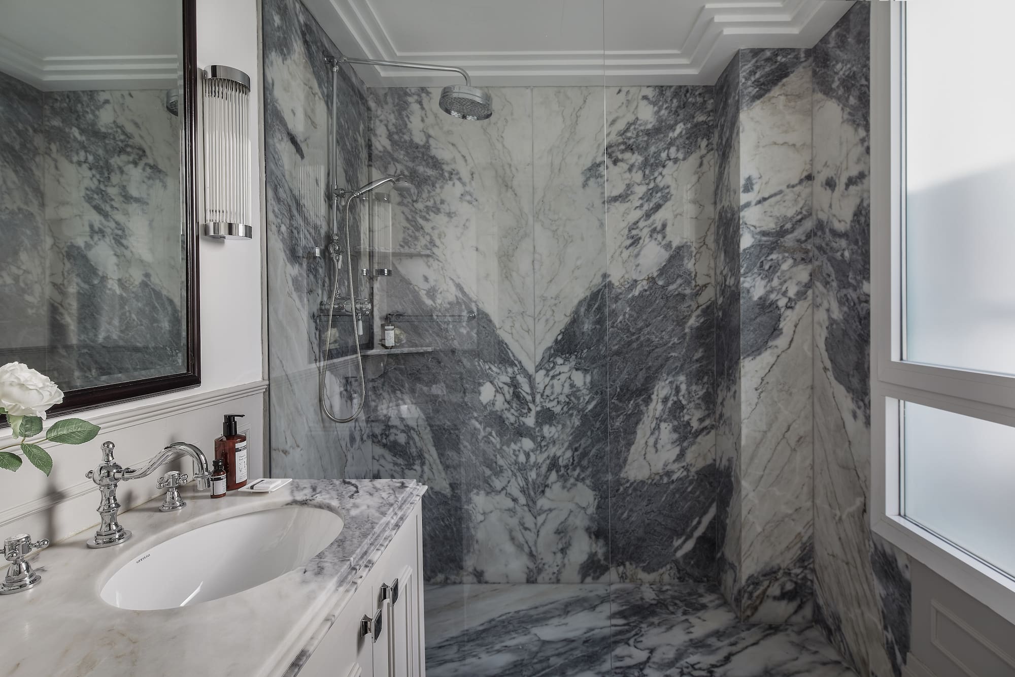 a bathroom with marble walls and a sink