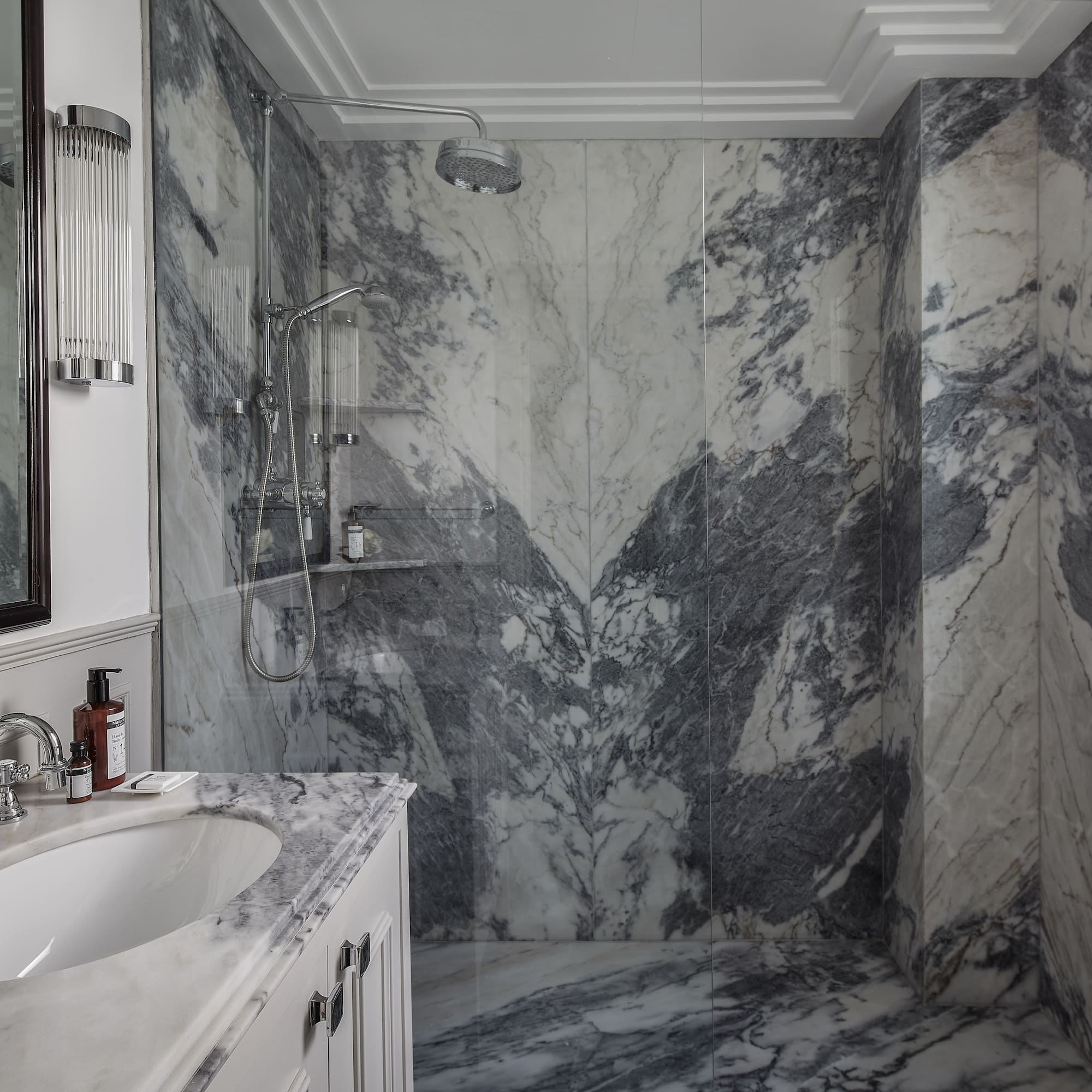 a bathroom with marble walls and a sink