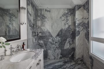 a bathroom with marble walls and a sink