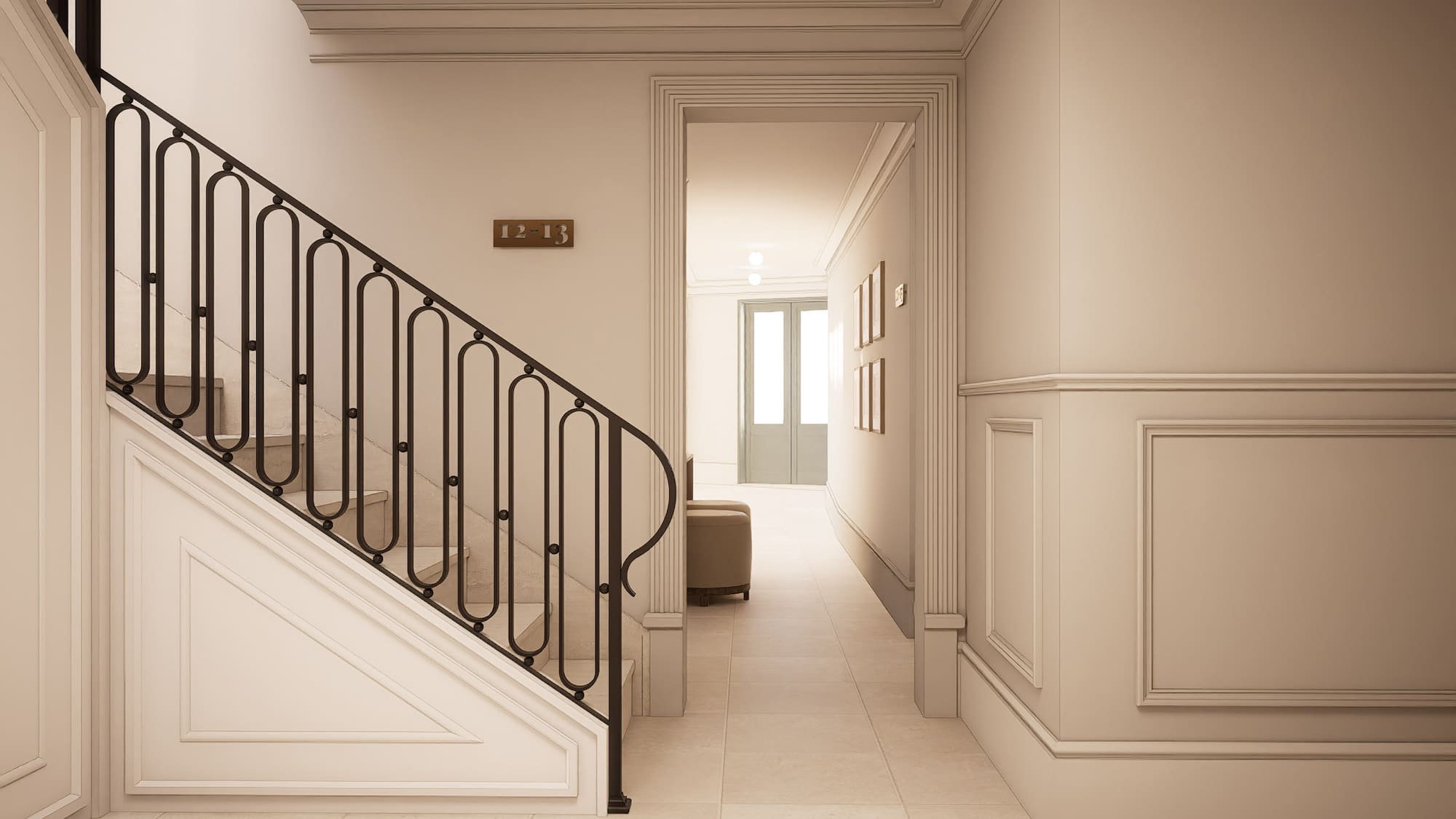 Elegant residential hallway with staircase, black wrought iron railing, and cream walls.