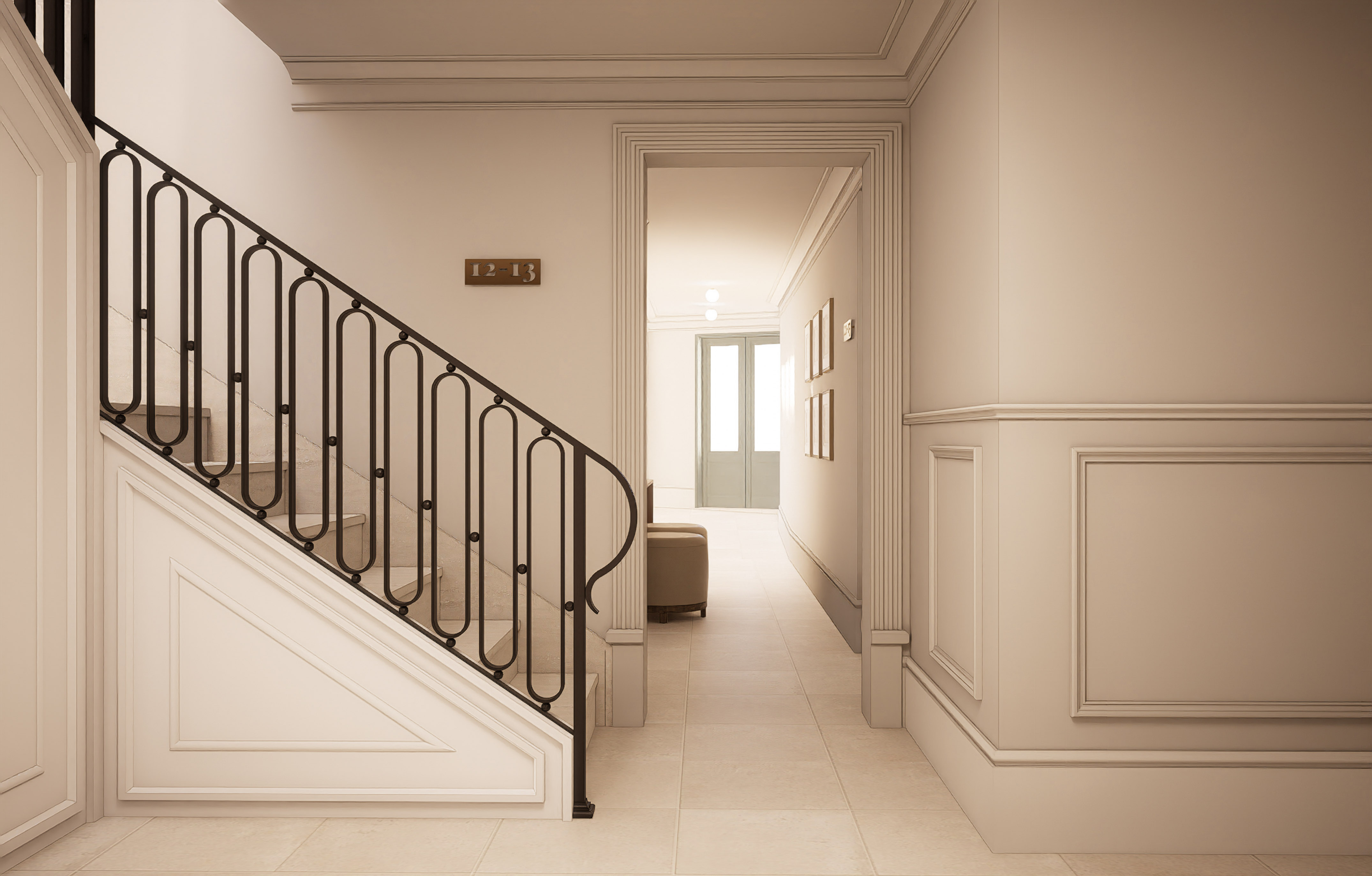 Elegant residential hallway with staircase, black wrought iron railing, and cream walls.
