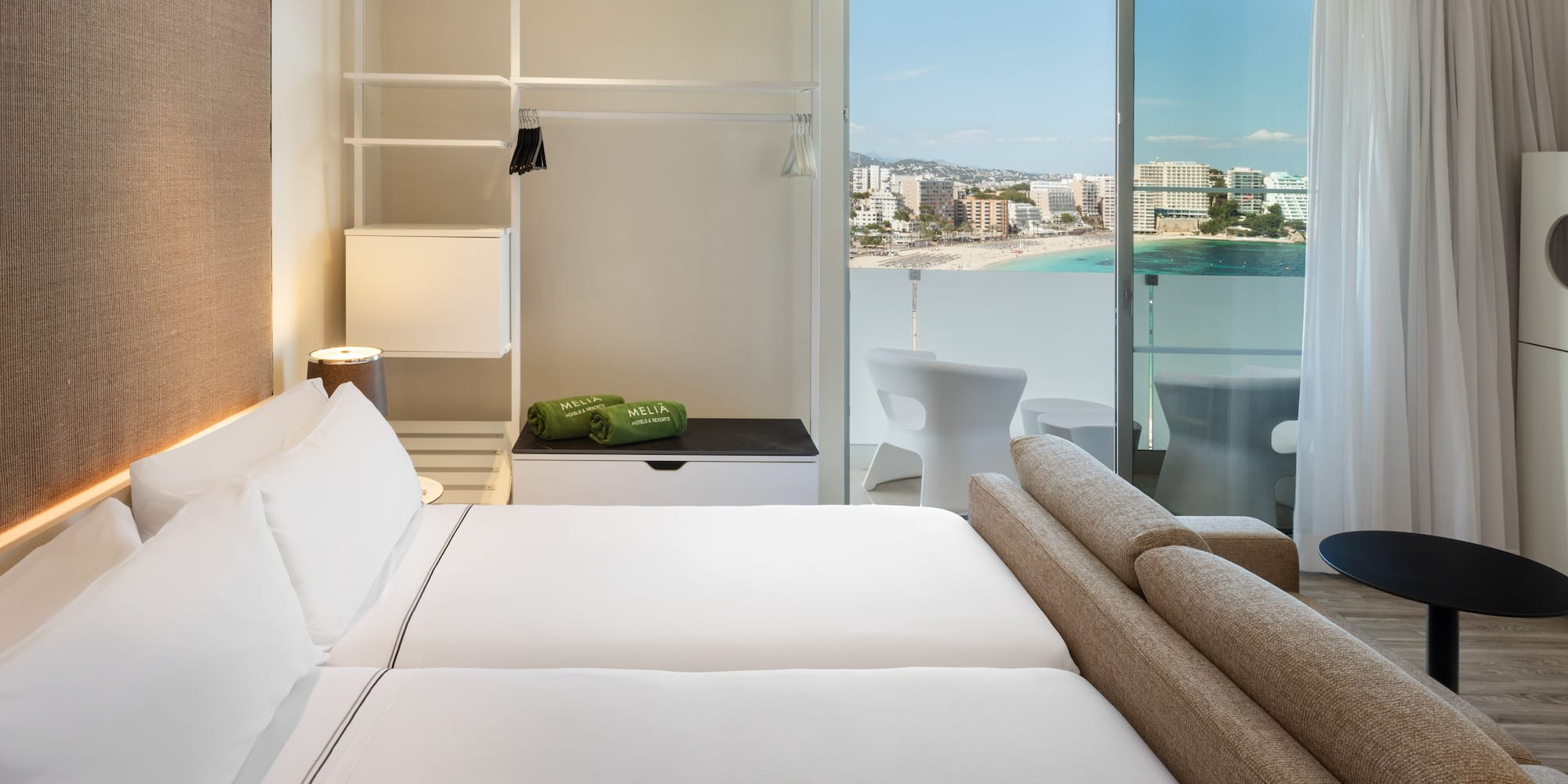 a hotel room with a view of the beach and a balcony