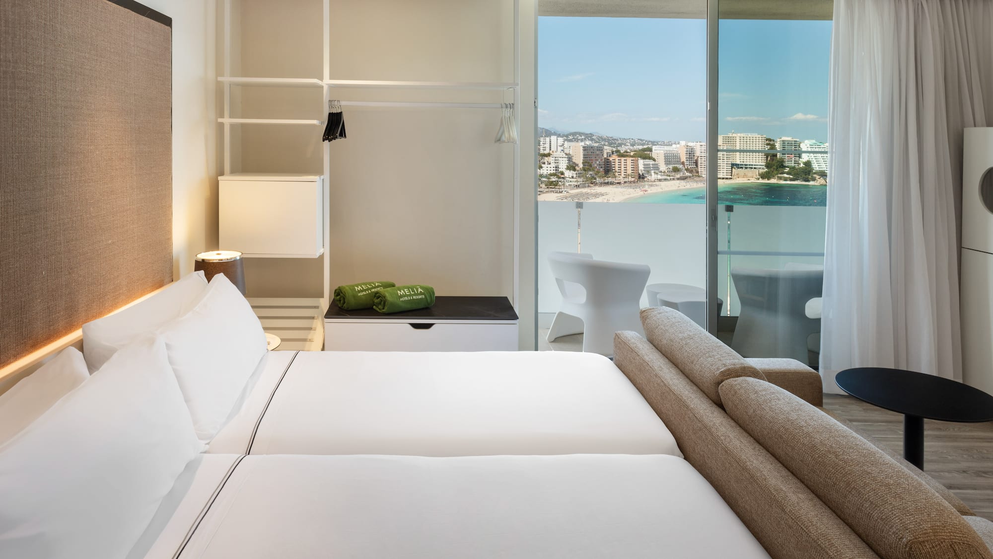 a hotel room with a view of the beach and a balcony