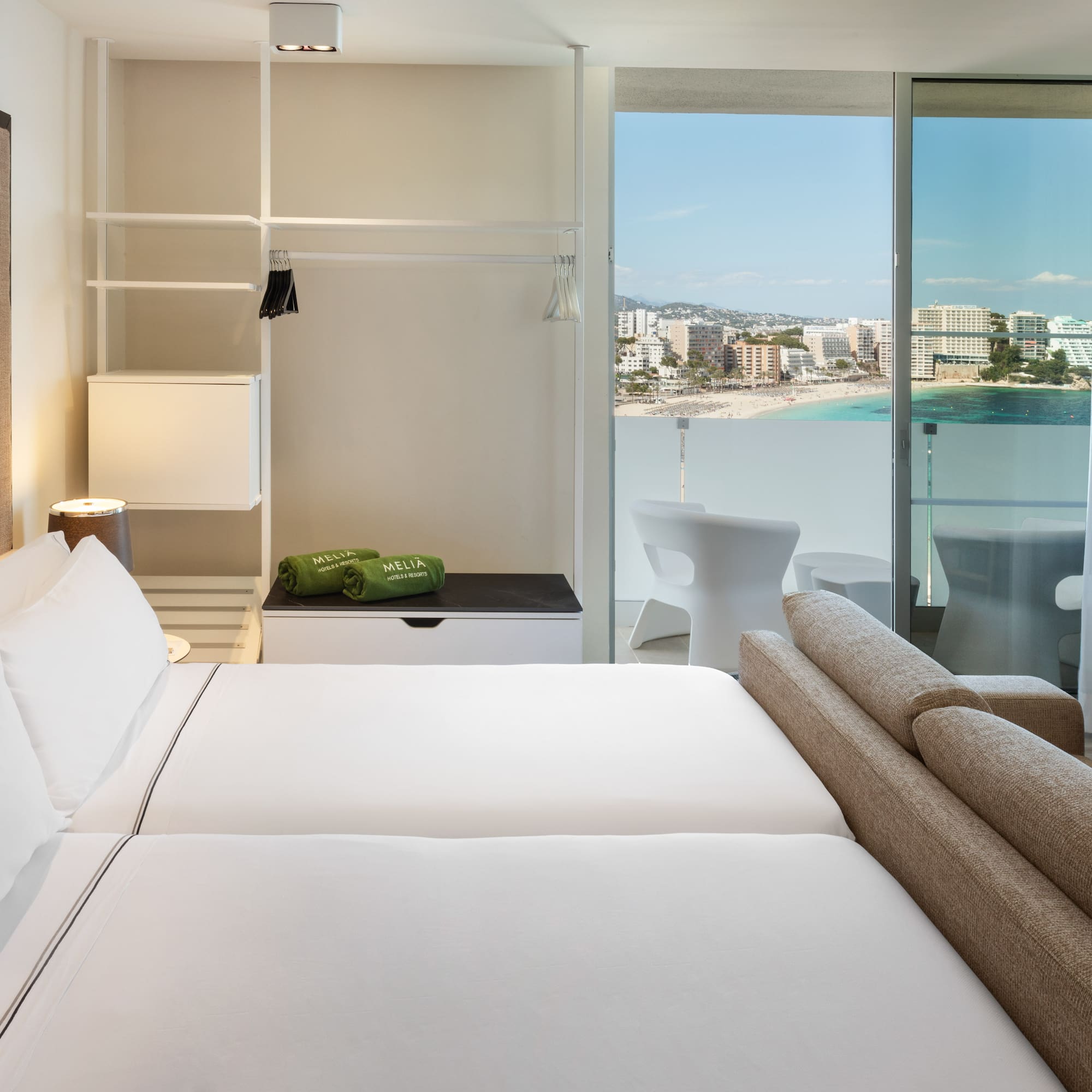 a hotel room with a view of the beach and a balcony