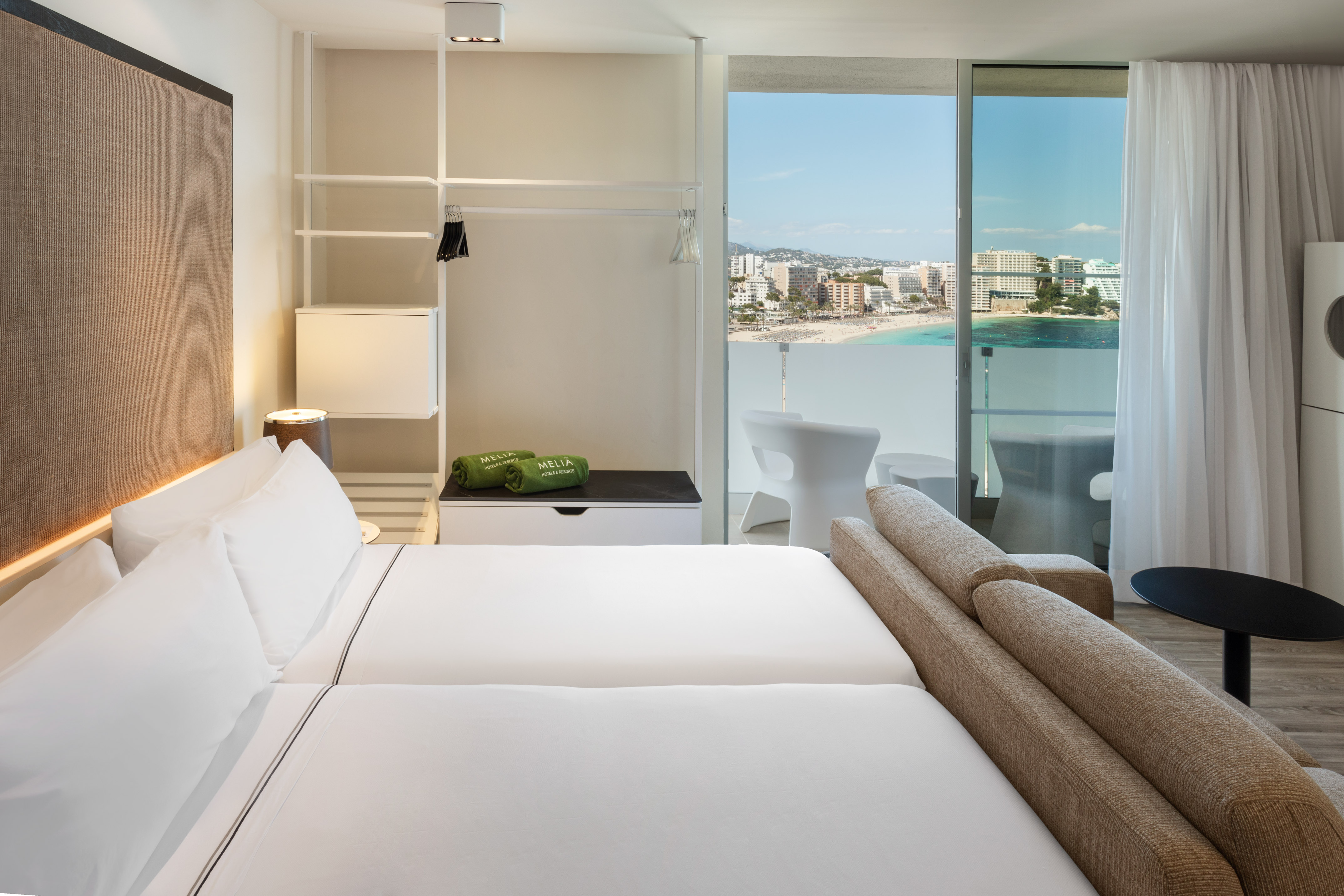 Melia hotel room with beach view balcony, modern design, and twin beds.