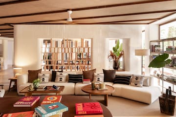 a living room with a white couch and coffee tables