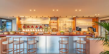 a kitchen with a counter and stools