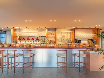 a kitchen with a counter and stools