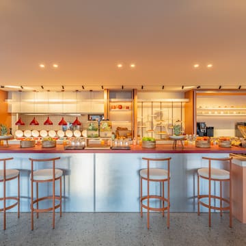 a kitchen with a counter and stools