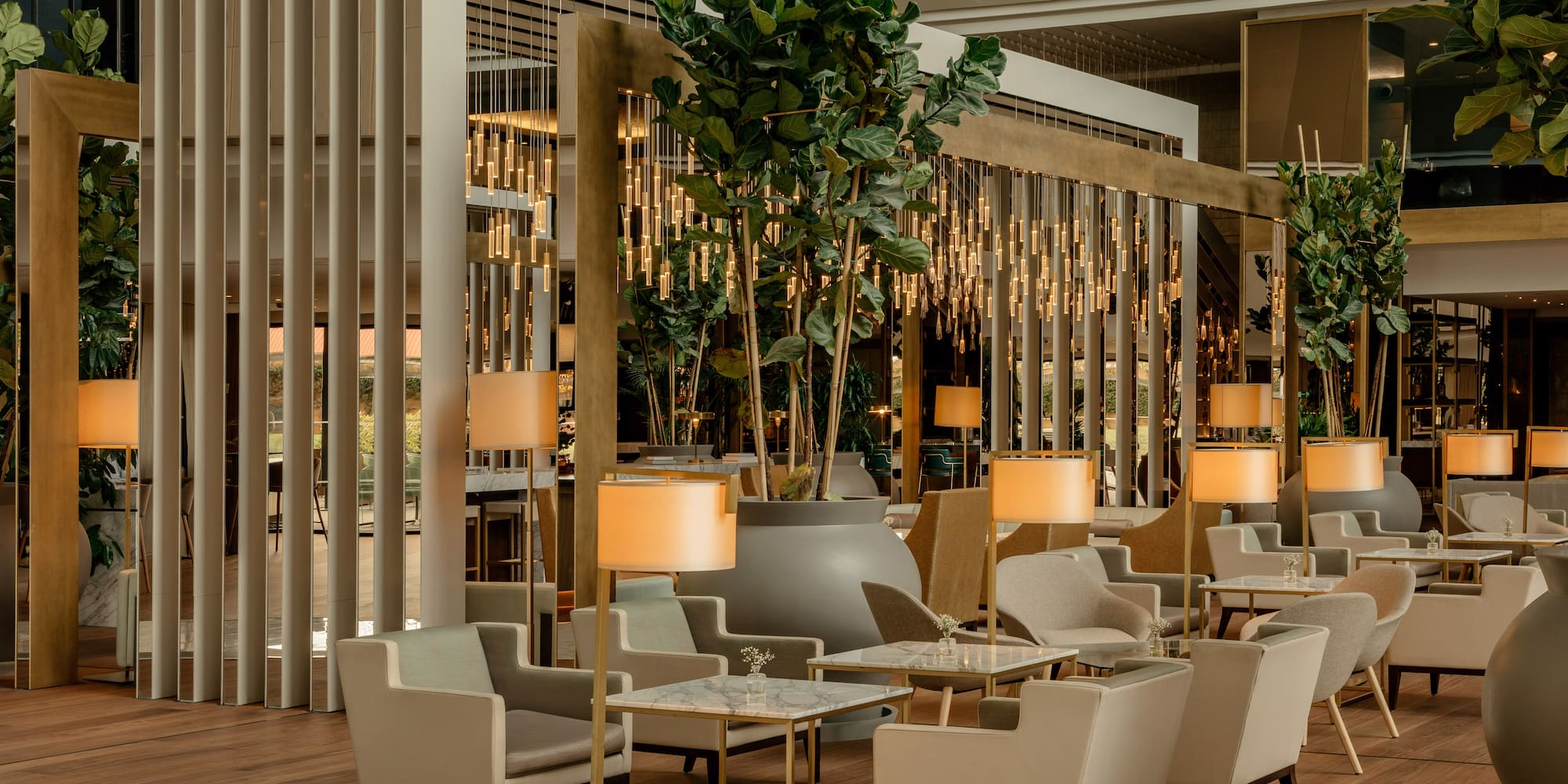 a room with tables and chairs and a plant