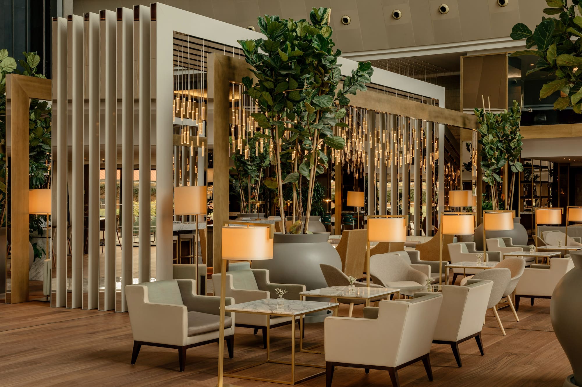 a room with tables and chairs and a plant