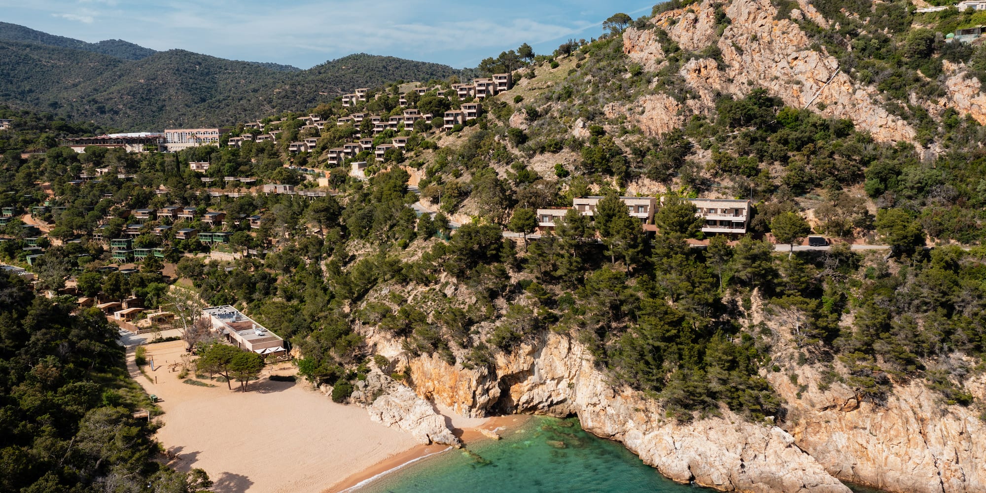 a beach and buildings on a hill