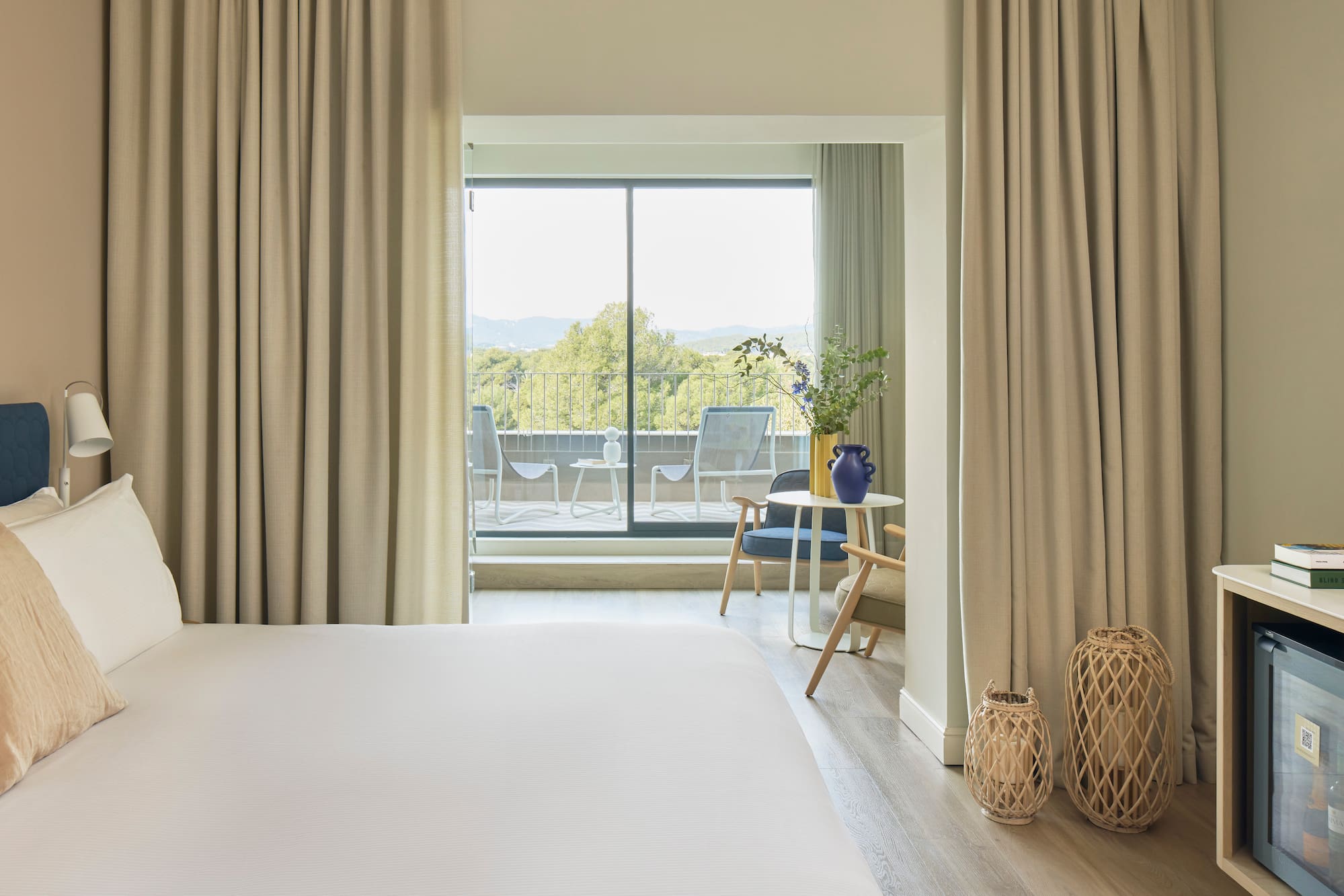 a bedroom with a large window and a bed