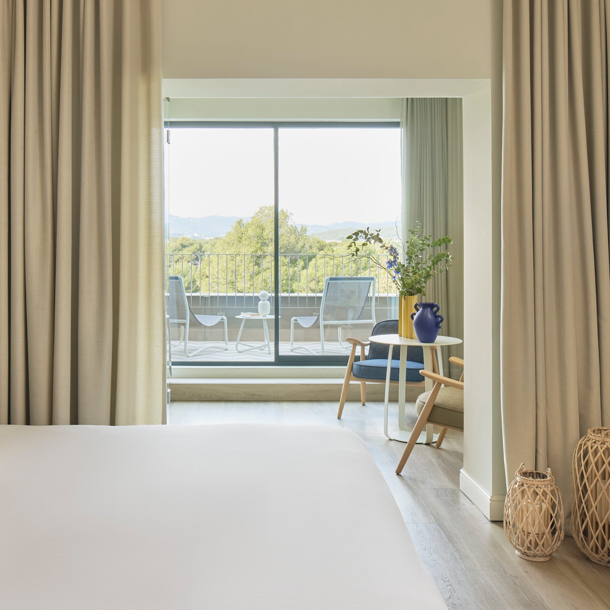 a bedroom with a large window and a bed