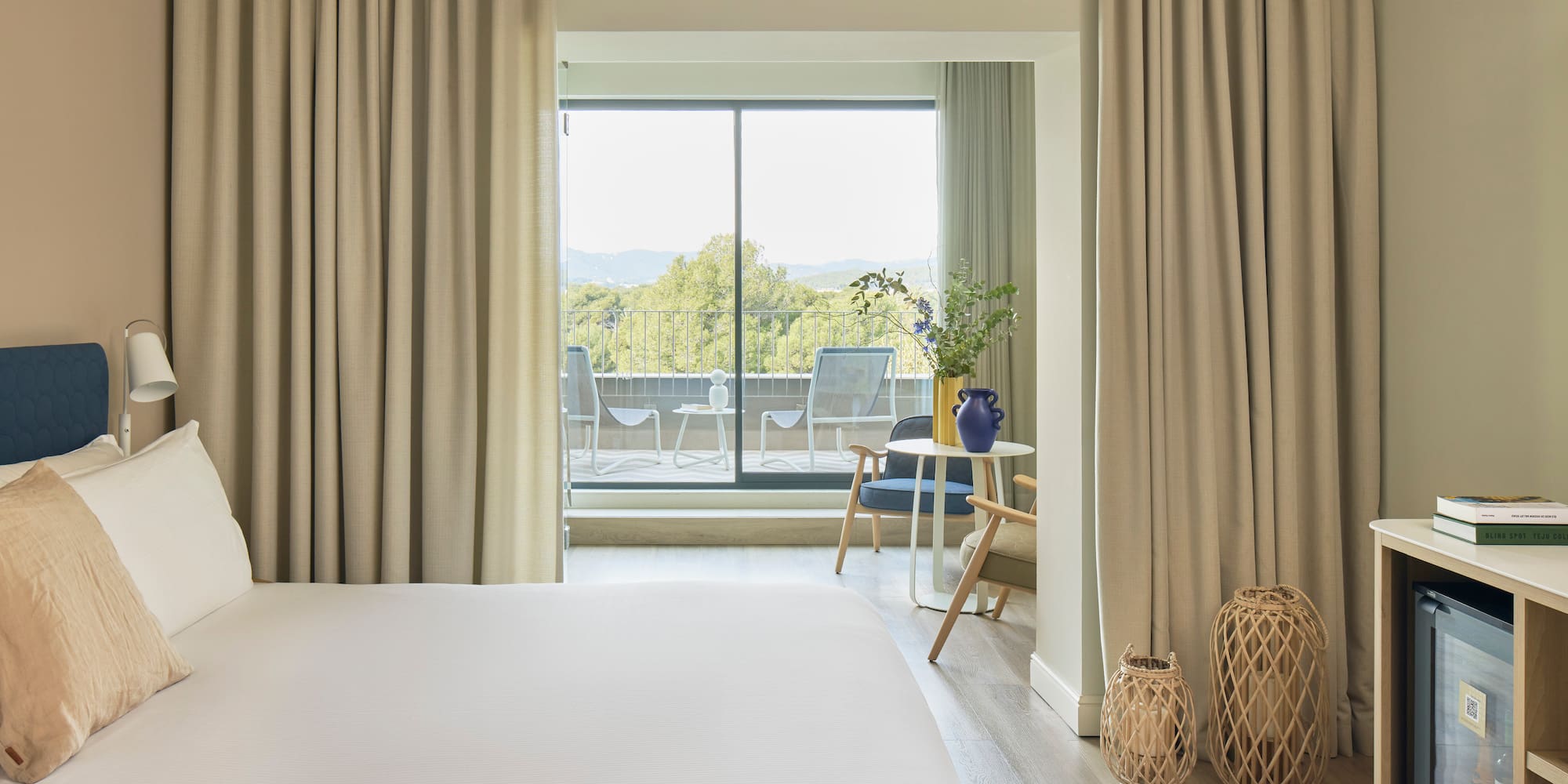 a bedroom with a large window and a bed