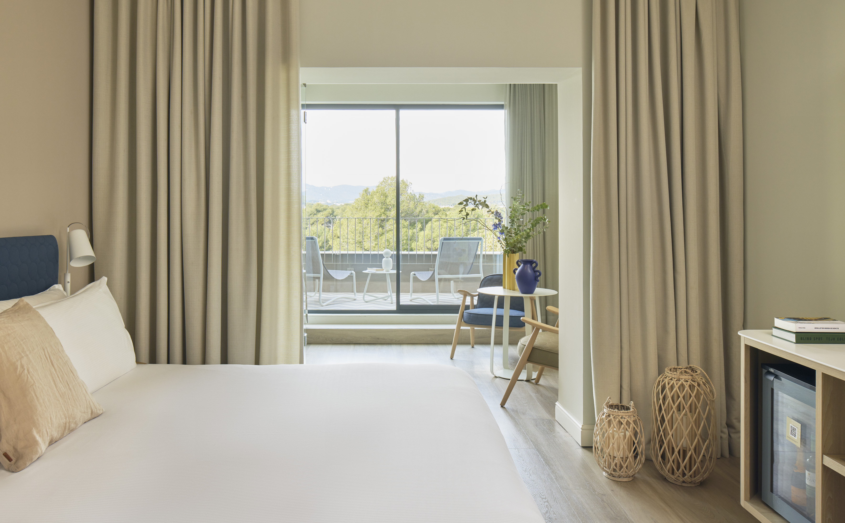 a bedroom with a large window and a bed