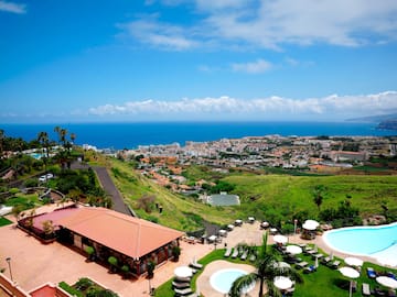 a pool and buildings on a hill