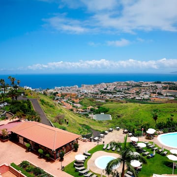 a pool and buildings on a hill