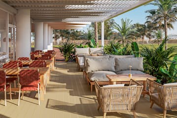a patio with chairs and tables