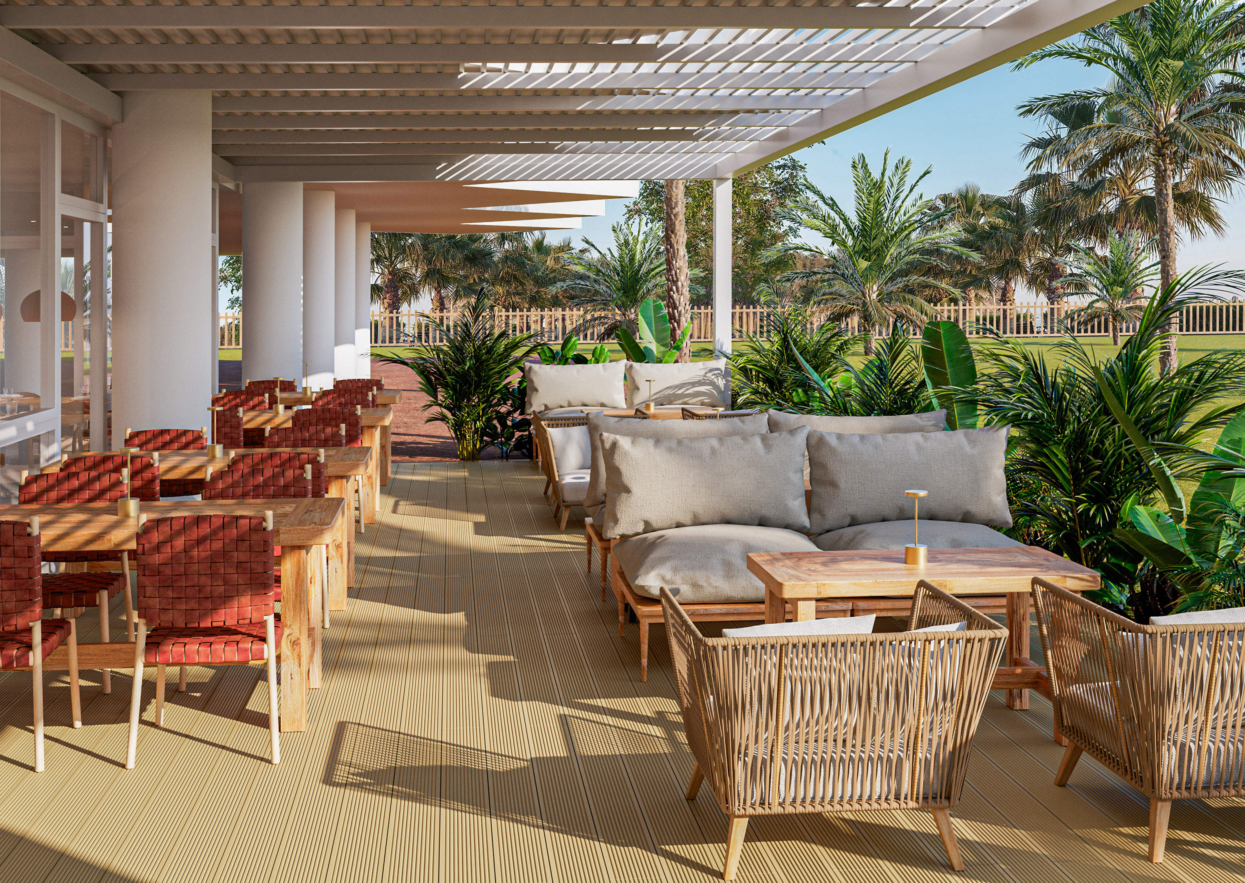 Outdoor dining patio at a tropical resort with lounge seating and palm trees.