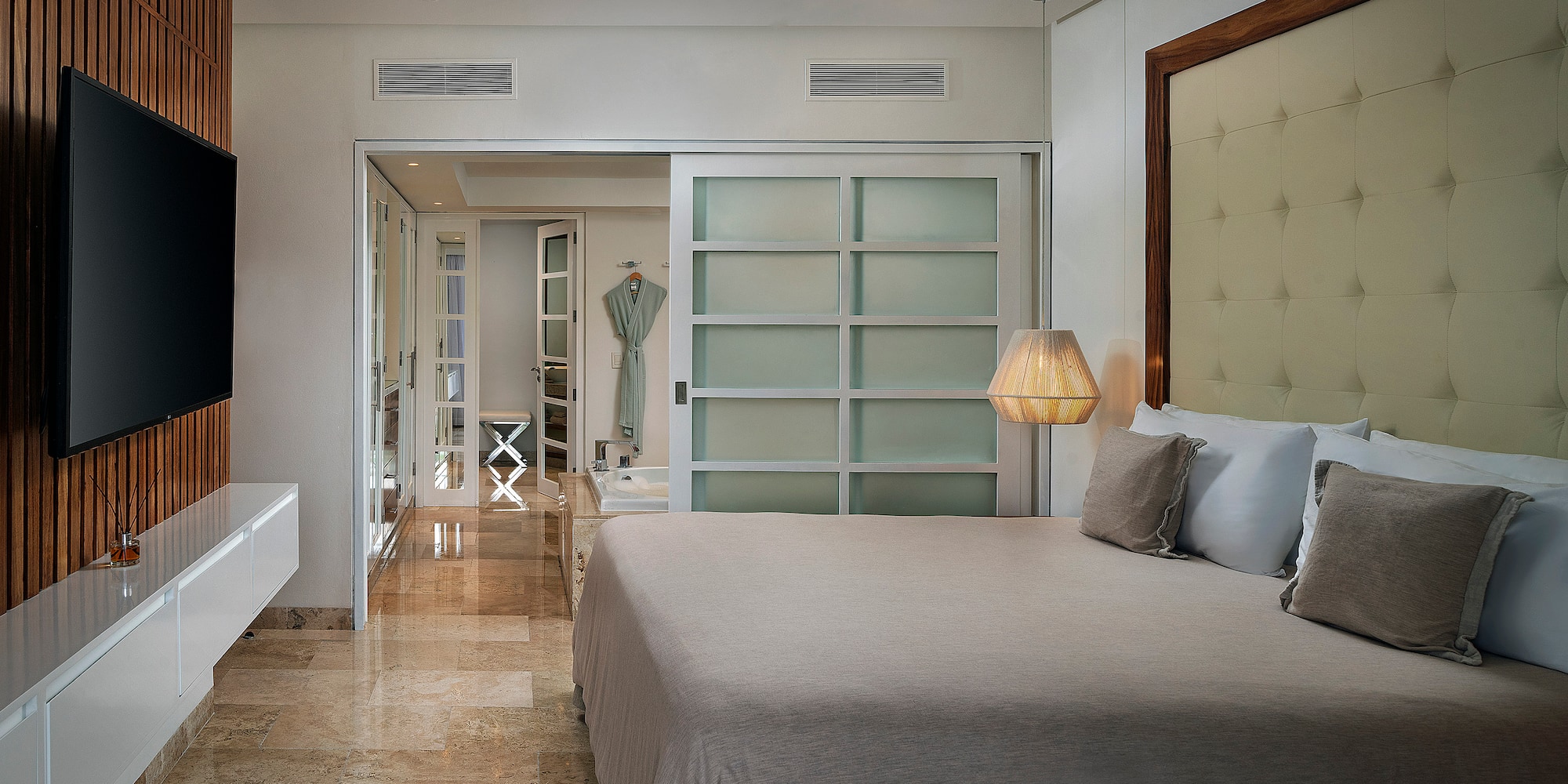 a bedroom with a bed and a mirror