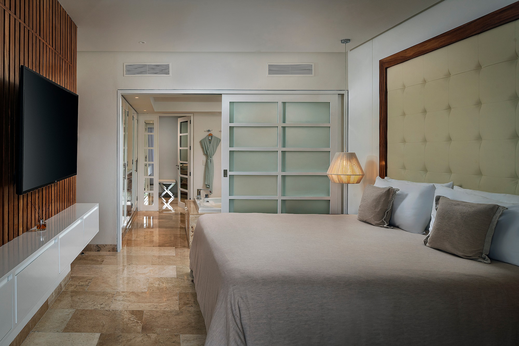 a bedroom with a bed and a mirror