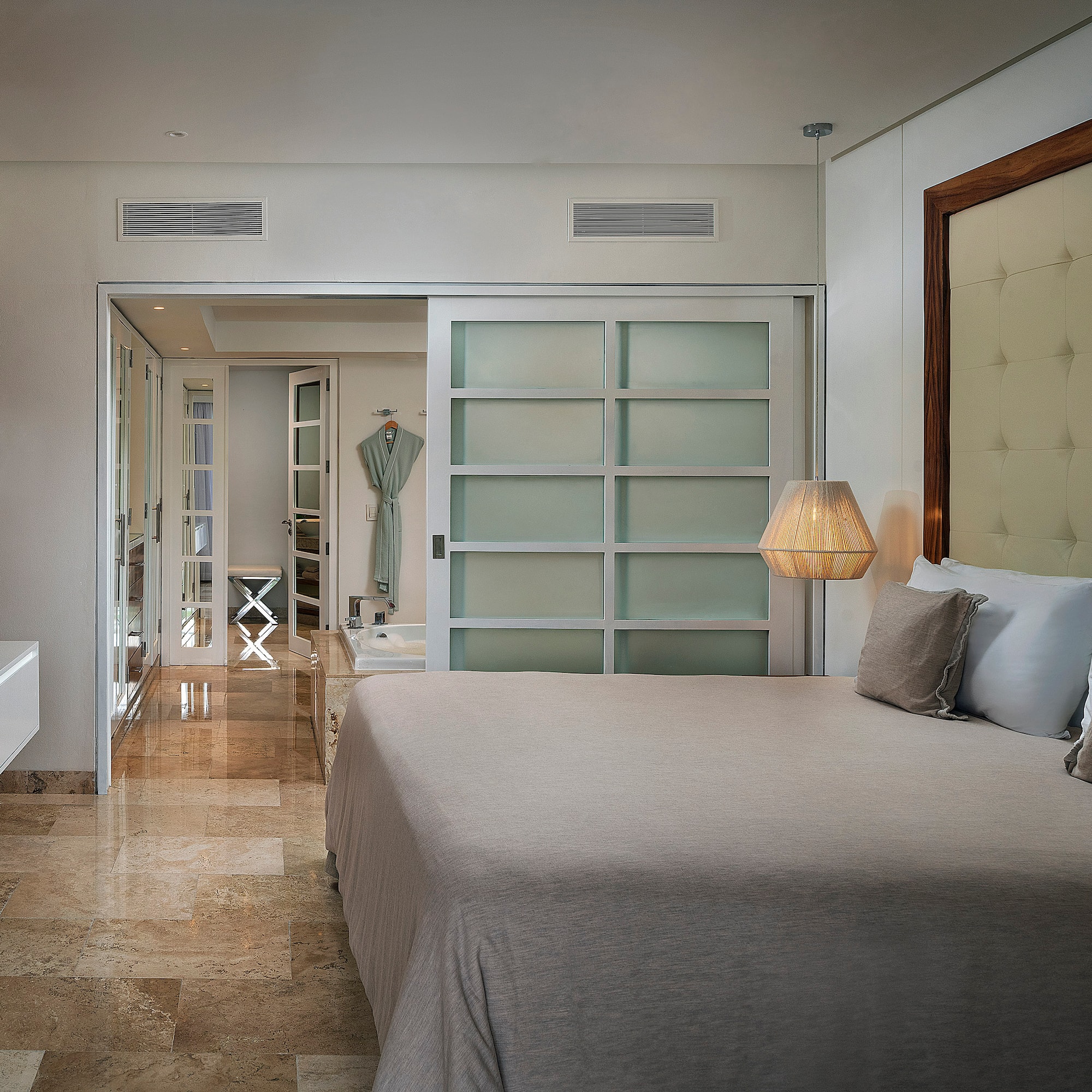 a bedroom with a bed and a mirror