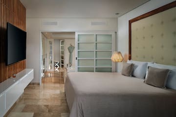 a bedroom with a bed and a mirror