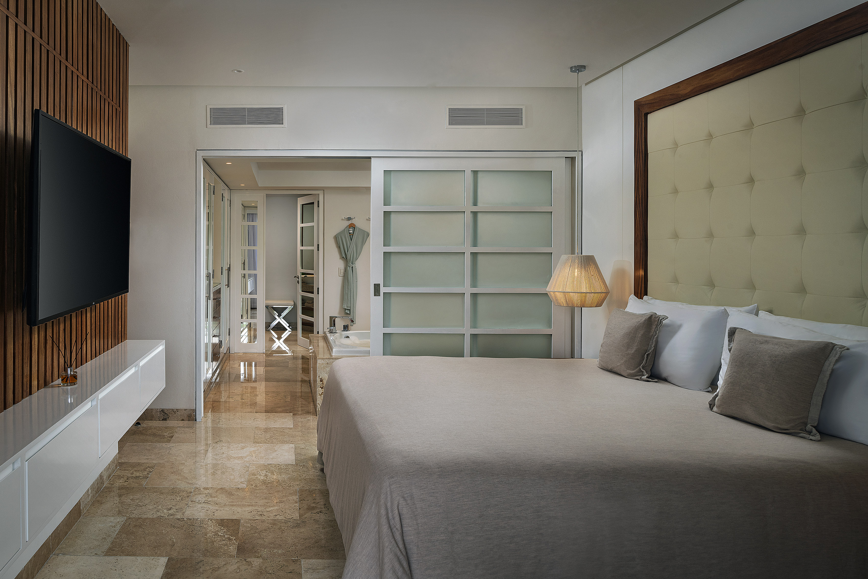 a bedroom with a bed and a mirror