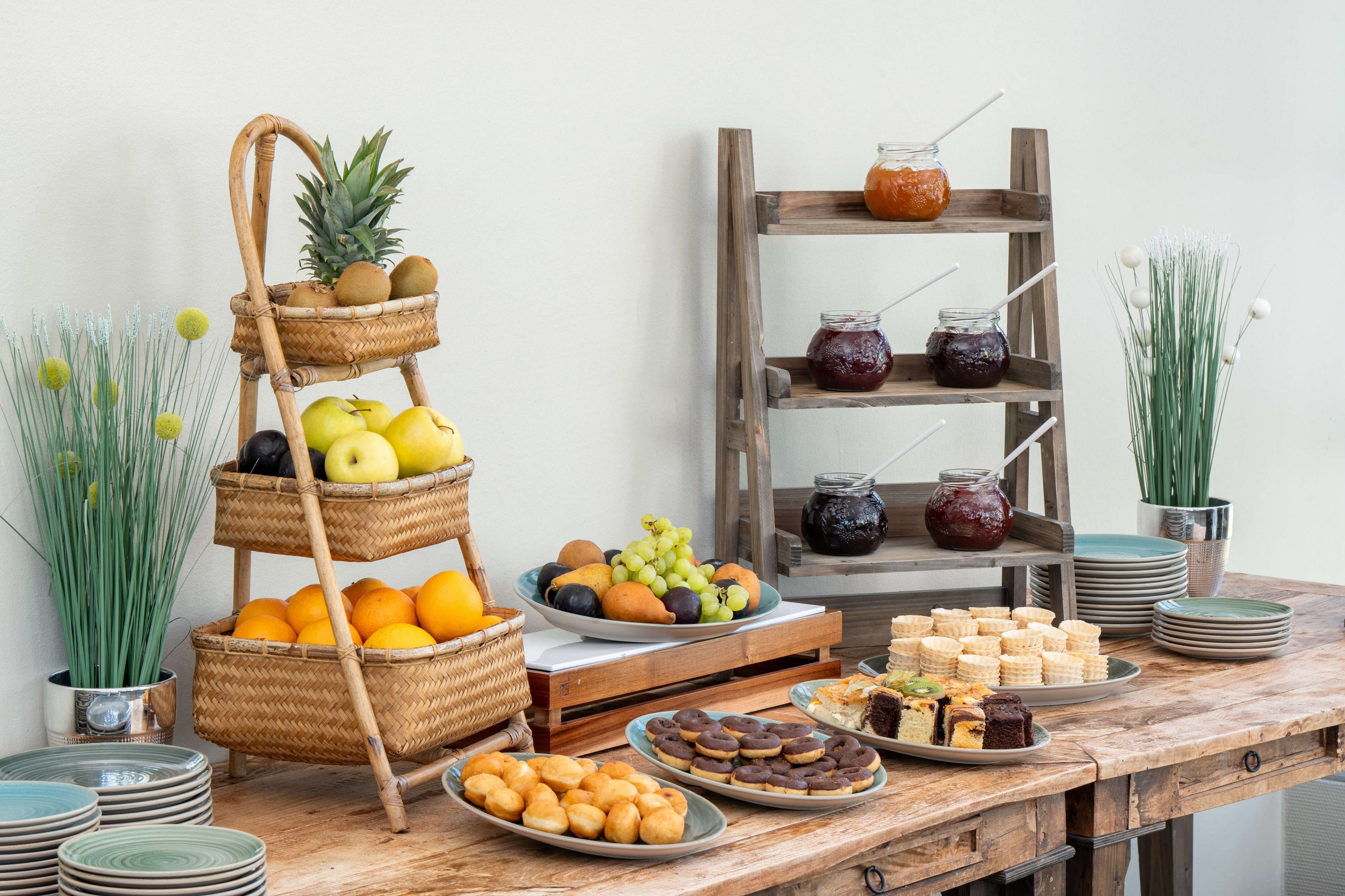 Hotel breakfast buffet: fresh fruit, assorted jams, pastries, and mini donuts.